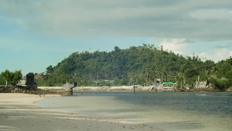 a view of the unfinished bridge supposedly connecting union road and nearby communities to secret beach in siargao island, philippines.