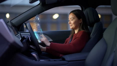 woman interacting with holographic display in a modern car
