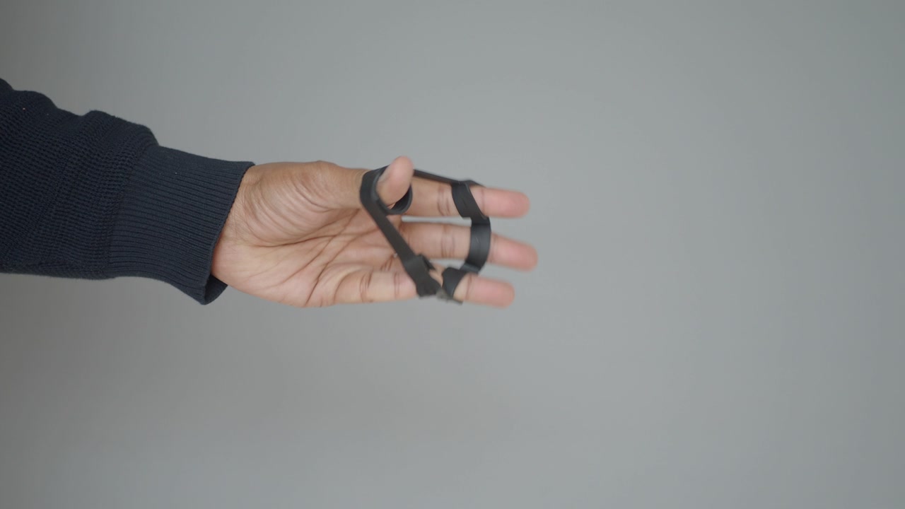 Close-up of Hand Using Finger Exerciser for Strength Training