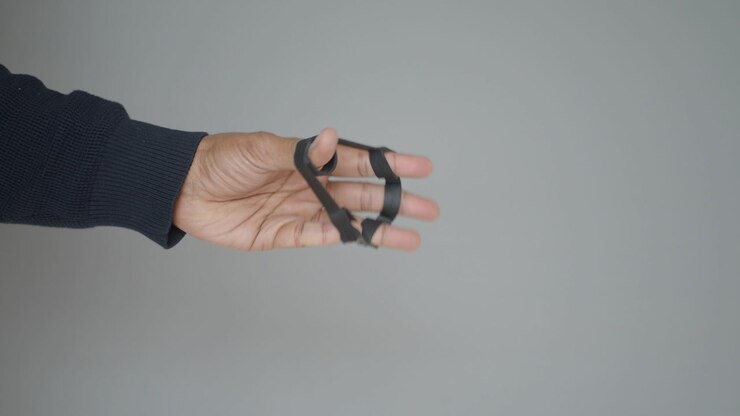 Close-up of Hand Using Finger Exerciser for Strength Training