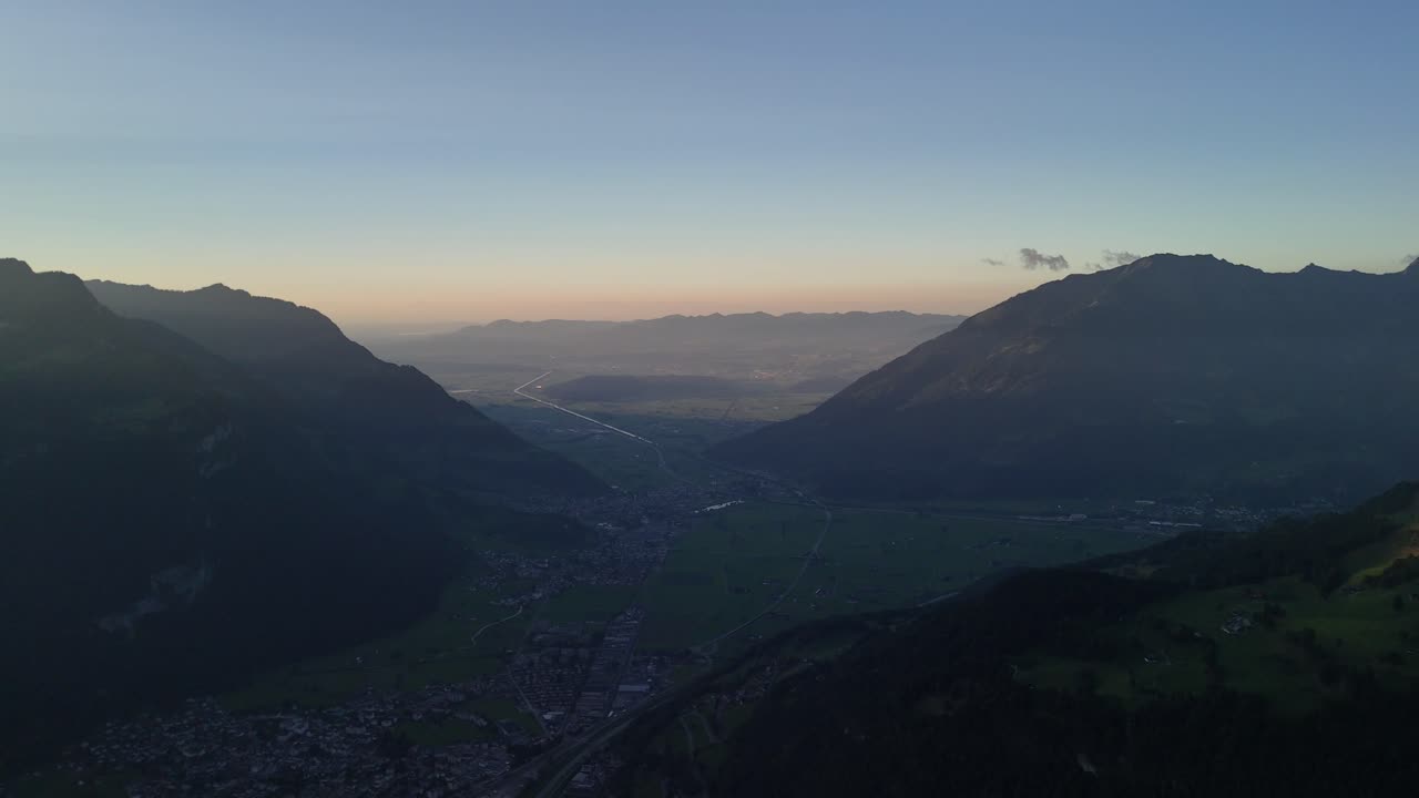 Village alpine region of Switzerland, aerial valley early morning, haze sky