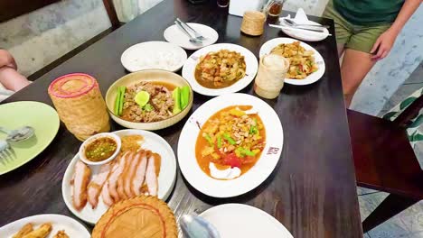 group sharing traditional thai dishes at a table