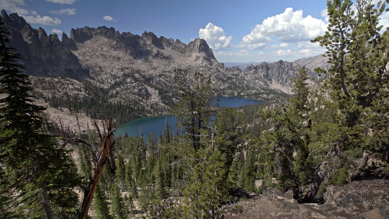 Panning up to emerald Baron Lakes in Sawtooth Mountains alpine landscape