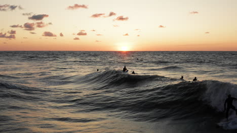 Surfers-in-front-of-the-touristic-town-Domburg-in-the-Netherlands-during-sunset