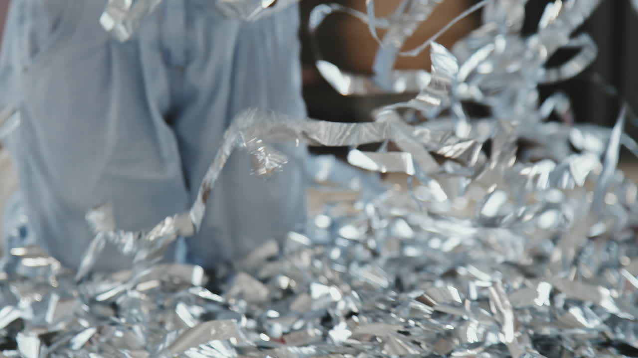 Unrecognizable Kids Playing with Silver Streamers