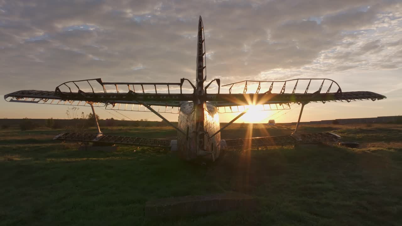 Drone shot of dismantled airplane in a sunlit field, Kalimantsi, Bulgaria