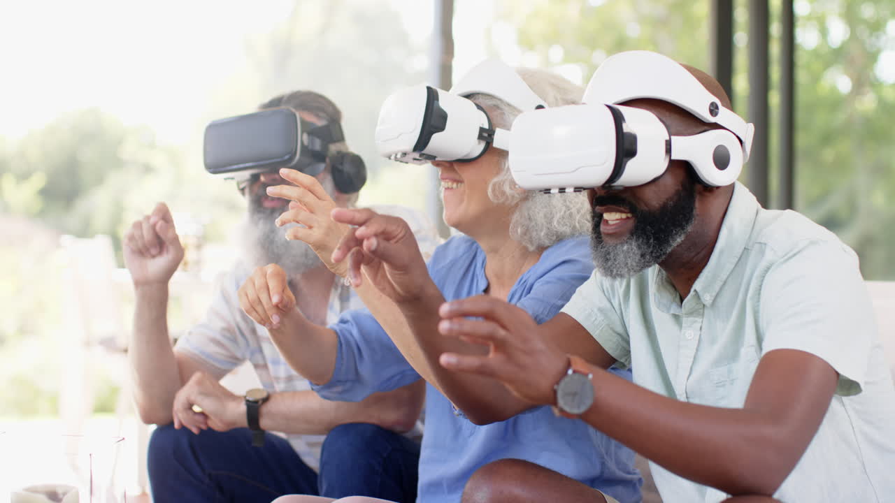Using VR headsets, senior friends enjoying virtual reality gaming together