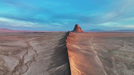 ship rock formation in the middle of vast desert in new mexico - aerial drone shot