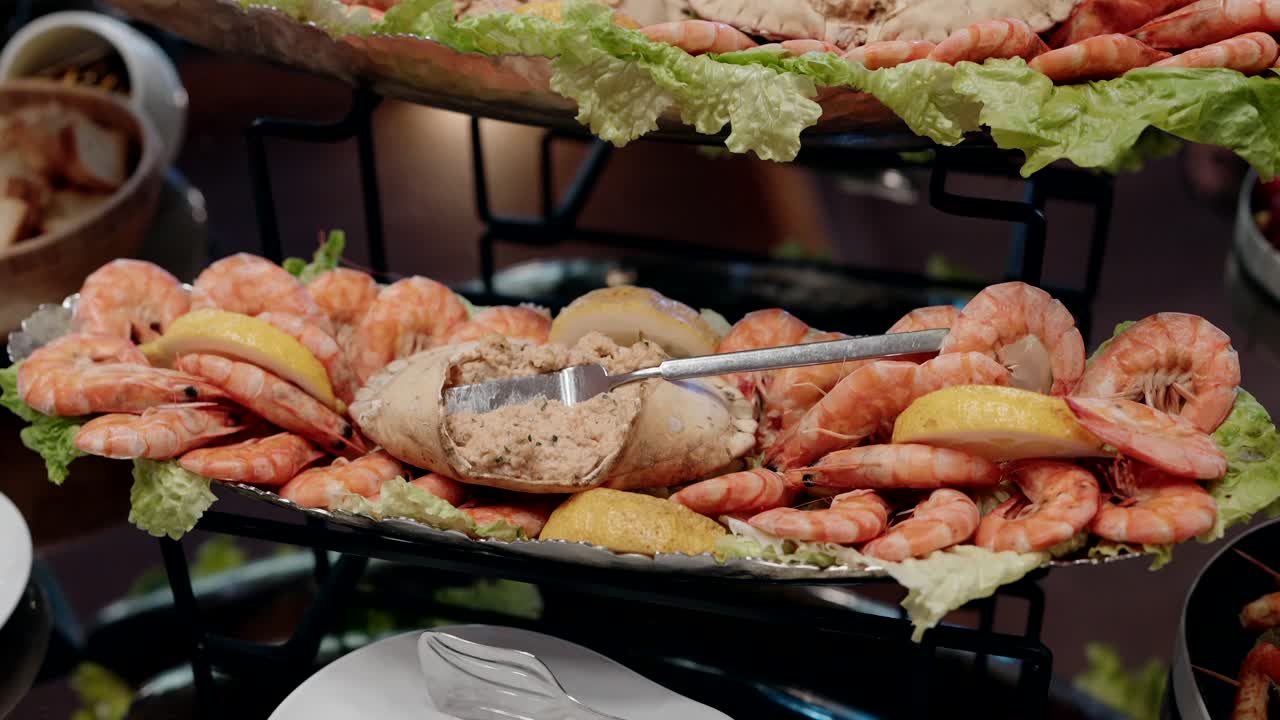 Shrimp platter with dip and lettuce on display at a catering event