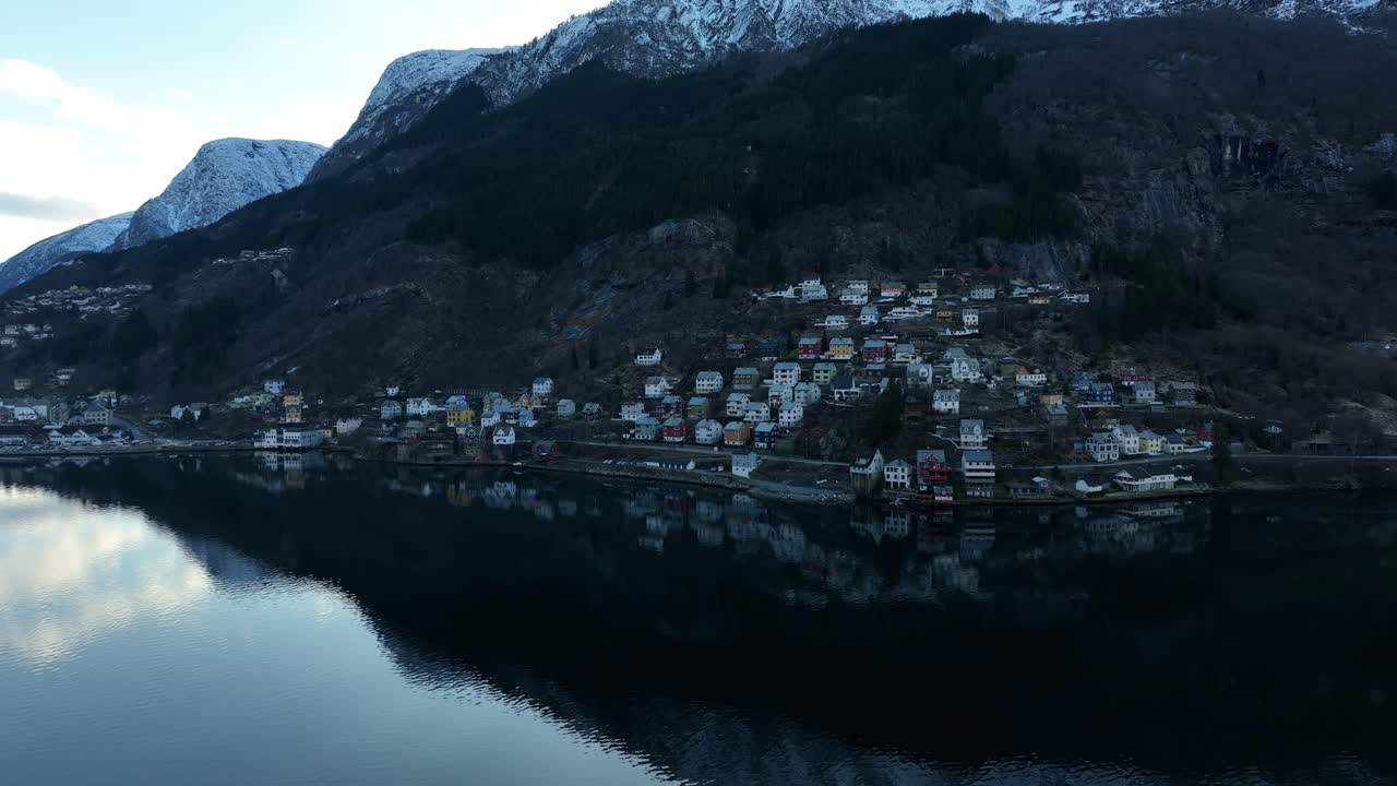 Aerial View of Kalvanes Neighborhood in Odda Norway at Dawn with Snow Capped Mountains