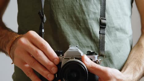 male photographer standing with digital camera in photo studio 4k