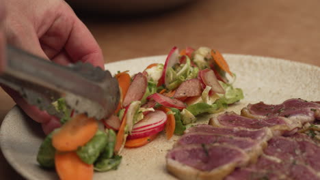 plate of medium rare turkey breast with vegetables on the side