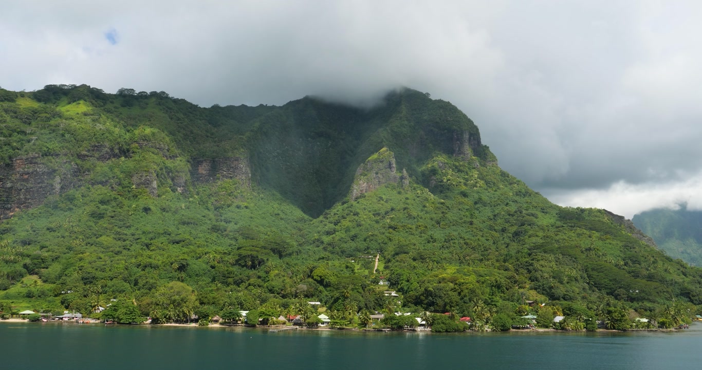 Low clouds over the mountain peak in Moorea, French Polynesia. View from Opunohu Bay.