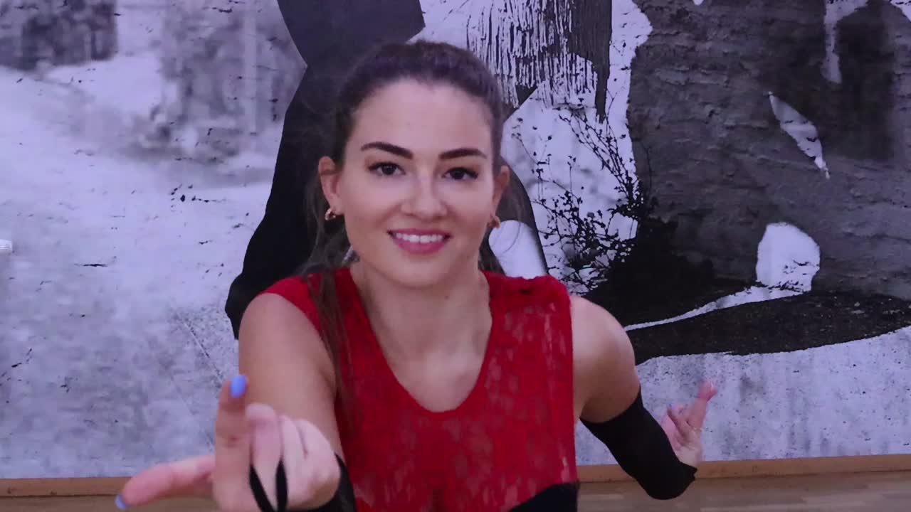 Female dancer leads the camera with her hand