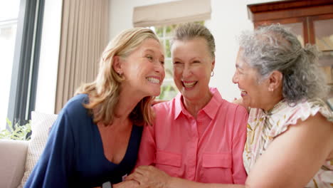 caucasian and senior biracial women share a joyful moment at home