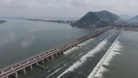 aerial view of the krishna river with the prakasam barrage crossing it.