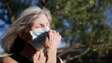 an aging woman patient with an illness breathing fresh air and smiling with hope after being treated for her disease