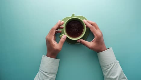 person holding a cup of tea or coffee