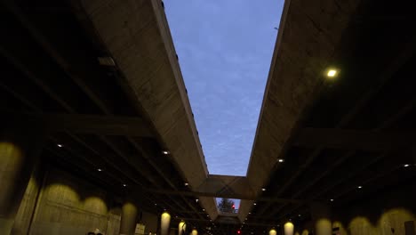 walking under a large bridge