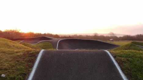 eboarder riding around a bmx pump track