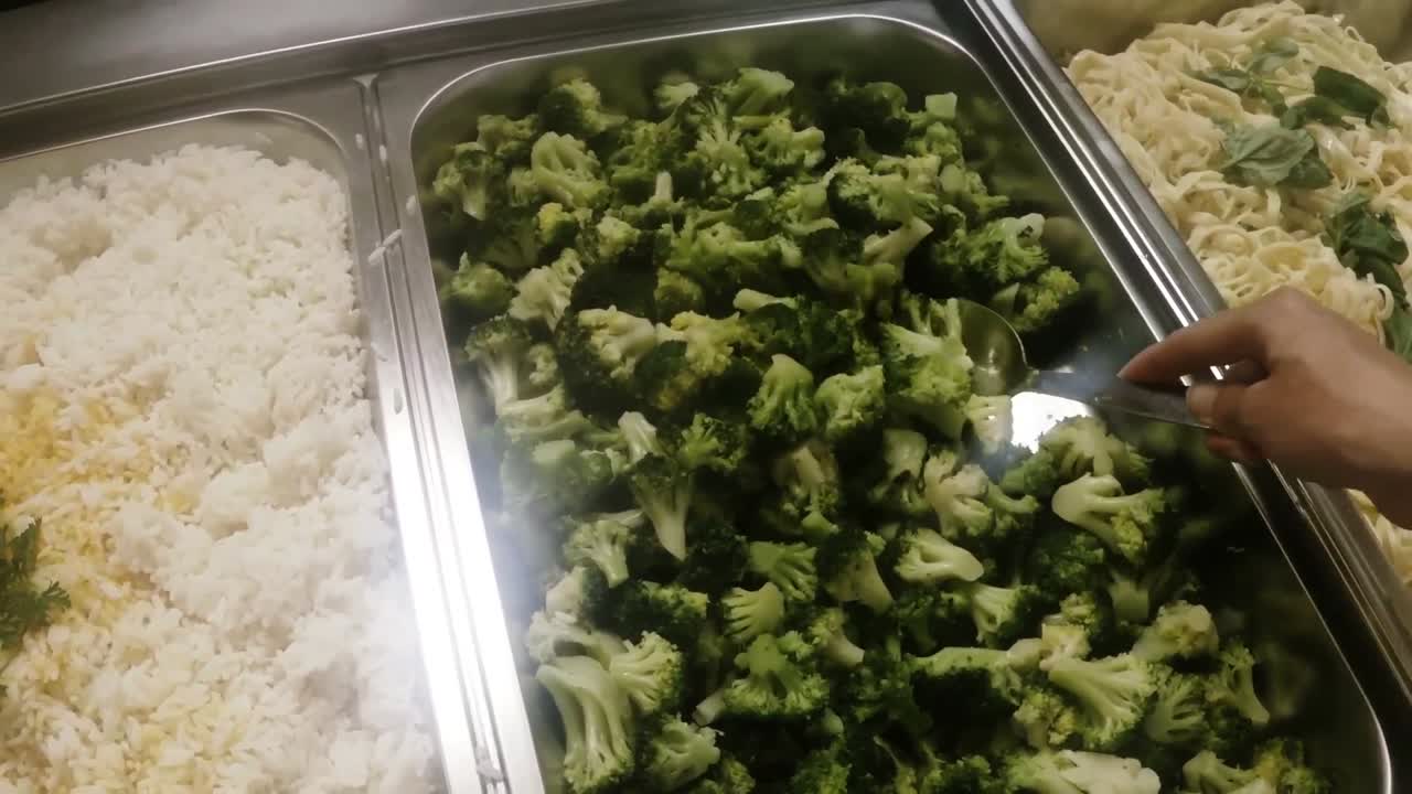 Hand of chef mixing food with a spoon