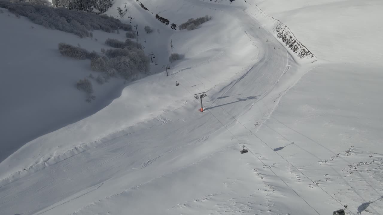 A ski trail winding through a snowy forest, inviting skiers to explore the winter beauty
