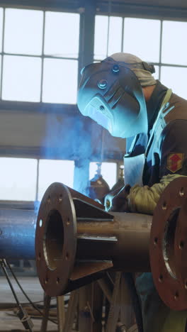 welding operation on metal pipes in factory