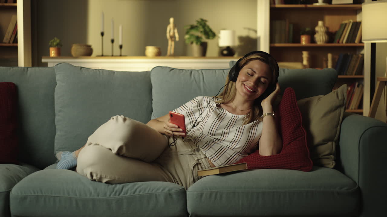 Woman relaxing on couch listening to music