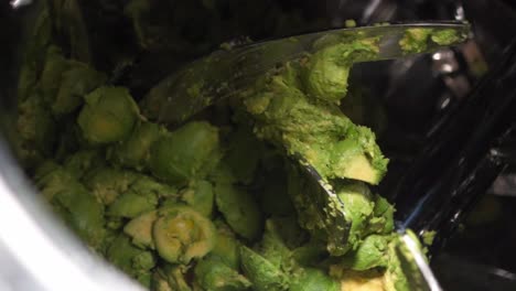 AVOCADOS  BEING PROCESSED INTO GUACAMOLE