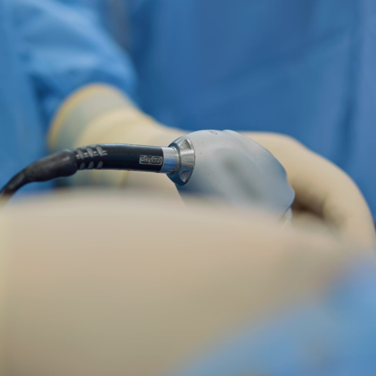 Surgical device in the gloved hand of a doctor. Close up. Tool for minimally invasive operation