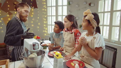 chef explaining recipe to kids on cooking masterclass