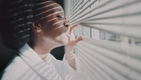 Black-woman,-blinds-and-tea-spy-out-window