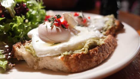 avocado toast with poached eggs and salad