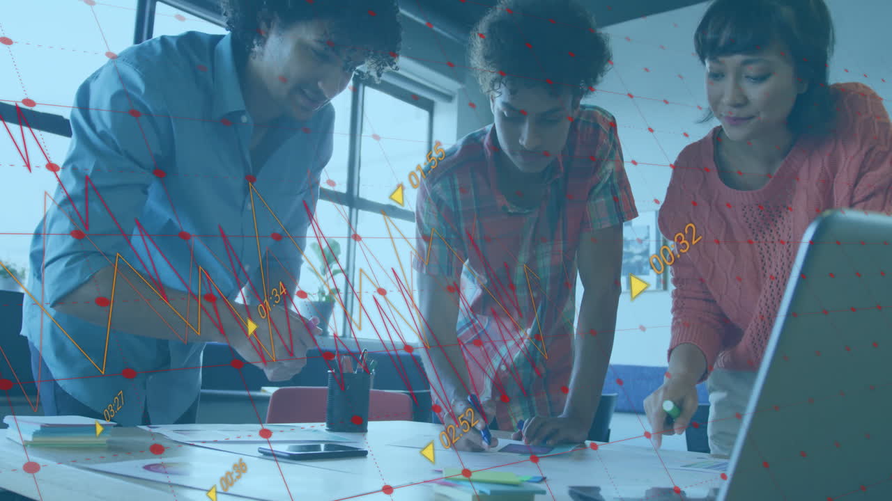 Analyzing data charts with animation overlay, diverse team in office setting