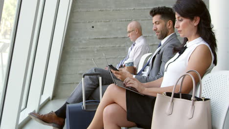 businesswoman using laptop in airport lounge shot on r3d