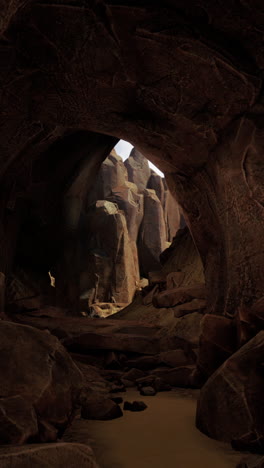 dark cave entrance with rocky mountain view