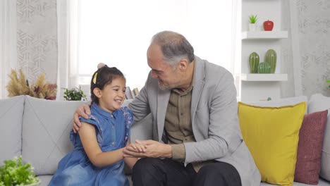 Emotional-grandfather-is-chatting-with-his-grandson-at-home.