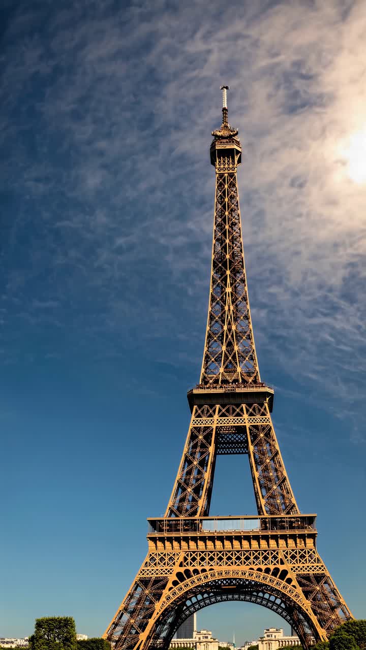 Video concept of the Eiffel Tower from a low-angle view, capturing its grandeur against a clear blue