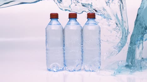 fresh drinking water bottles in splash blue water. shot on super slow motion camera 1000 fps.