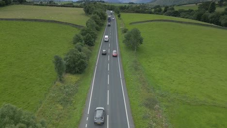 busy countryside highway a66 with trucks and cars, slow rise up with mountainous horizon reveal