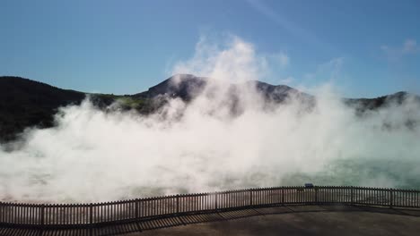 vapors and steam above natural pools in active geothermal springs, new zealand