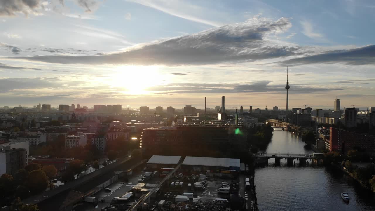 Drone time lapse at sunset in Berlin Germany with a view looking west along the river Spree and traffic moving across the bridge an road 4k