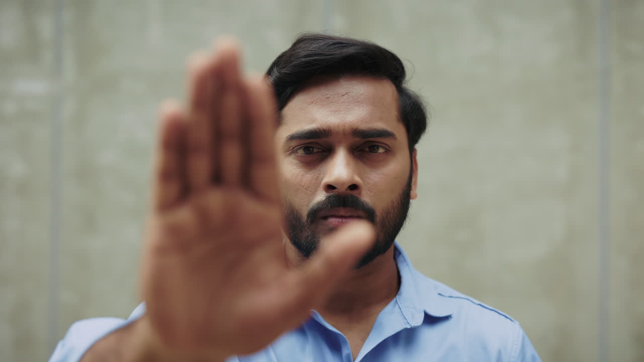 Man with hand up in a stop gesture