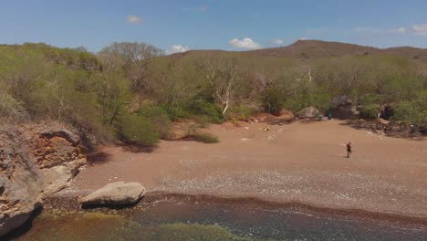 Aerial-view-of-a-black-sand-beach-secluded-on-the-west-coast-of-Curacao