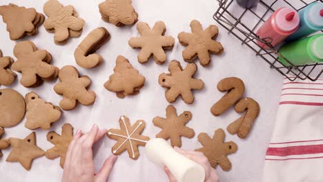 decorating gingerbread cookies with royal icing for christmas.