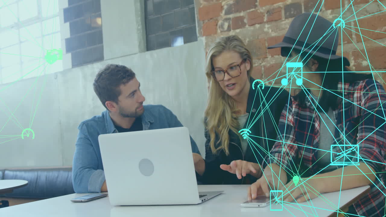 Collaborating at table, three people discussing digital network animation in school