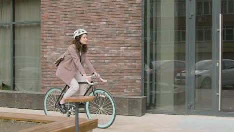 young woman in formal clothes going to work on bicycle 1