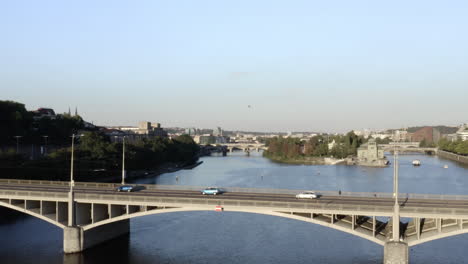 car traffic on a concrete bridge over vltava river,prague,czechia