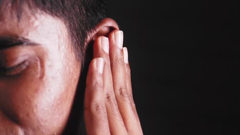 person holding their ear