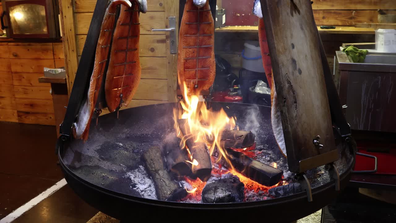 Smoked salmon on a fire pit, outdoor grilled food preparation